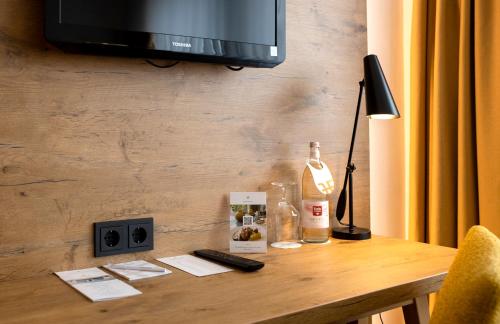 a table with a bottle of wine and a television at FischerS in Kassel