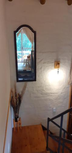 a mirror on the wall of a room at Balcon de Antares in Uspallata