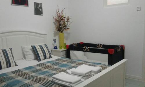 a bedroom with a bed with towels on it at Praça do Chile apartment in Lisbon