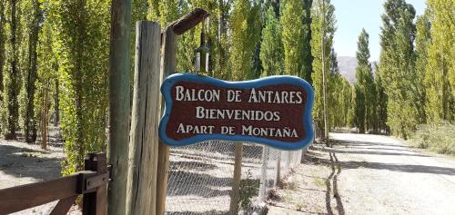 a sign on a fence next to a dirt road at Balcon de Antares in Uspallata