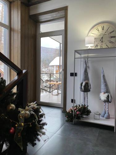 a living room with a clock and christmas decorations at Girske Povitria 2 in Yaremche