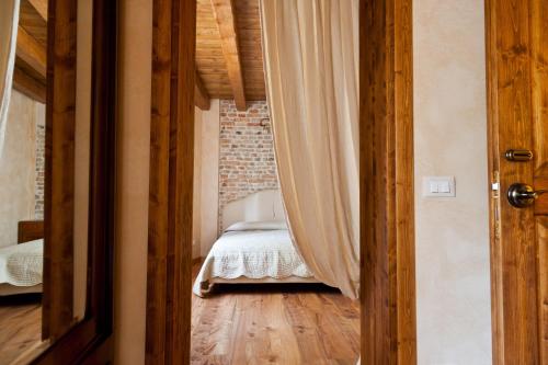 a bedroom with a bed and a brick wall at Ca' Muliner in Azzano Decimo