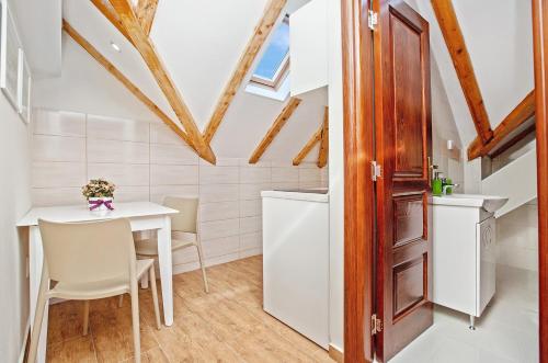 a kitchen and dining room with a table and chairs at Apartments Isja in Tivat