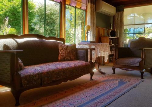a living room with a couch and a fireplace at Red Brier Cottage Accommodation in Richmond
