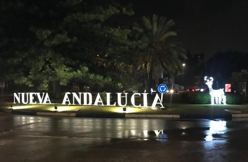 a sign that reads nucaya andalfelica at night at Suite Vitbanus in Marbella
