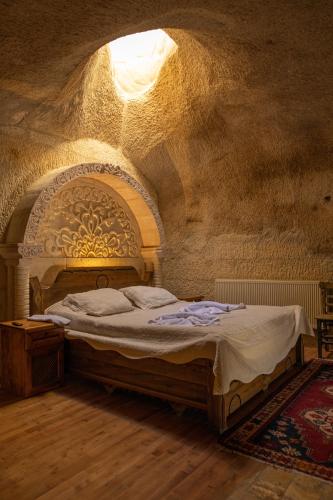 a bedroom with a bed in a stone room at Arif Cave Hotel in Goreme
