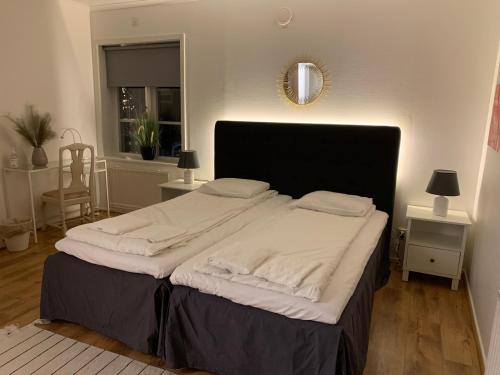 a bedroom with a large bed with white sheets at Annexet Kilafors in Kilafors