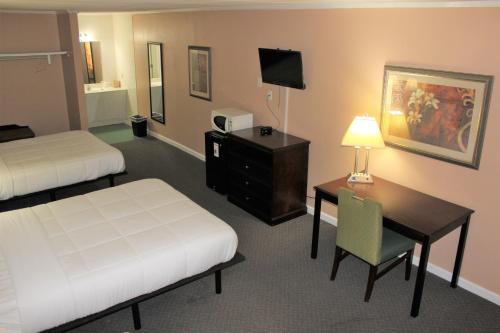 a hotel room with two beds and a desk and a desk at Bar-Mel Inn in McCormick