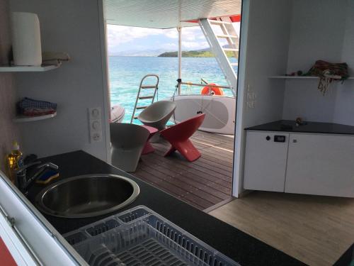 a kitchen with a view of the ocean from a boat at Aqualodge Martinique in Le Marin