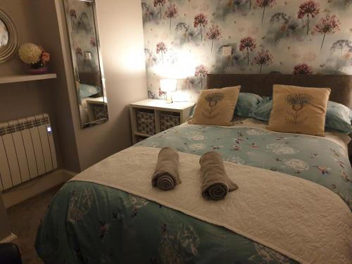a bedroom with a bed with two towels on it at Millie's place in Fort William