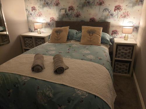 a bedroom with a large bed with two night stands at Millie's place in Fort William