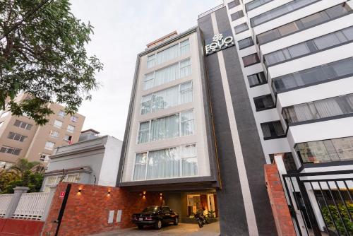 a building with a car parked in front of it at Equo Hotel Boutique in Lima