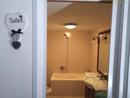 a bathroom with a tub and a sink and a bath tub at villa mina con vasca idromassaggio in Taranto