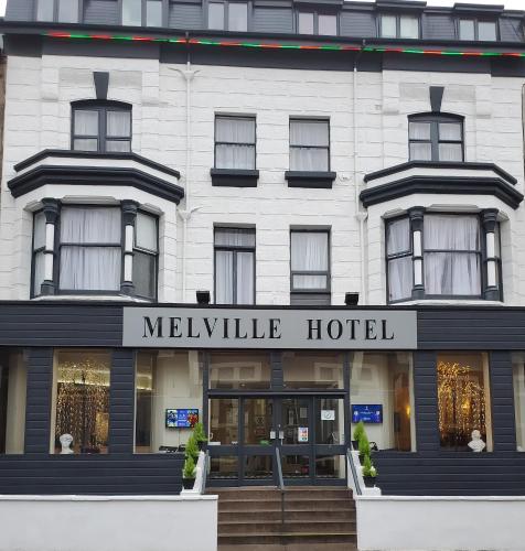 a white building with a melville hotel sign on it at The Melville Hotel - Central Location in Blackpool