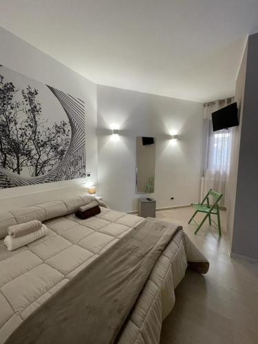 a bedroom with a large bed with a painting on the wall at Casa Nicola Maria in Grottaglie