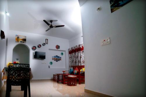 a living room with a ceiling fan and a couch at Bethel Service Villa, Mananthavady, Wayanad in Wayanad