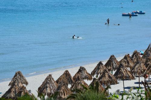 a group of people in the water on the beach at Residence Fenicia in Villasimius