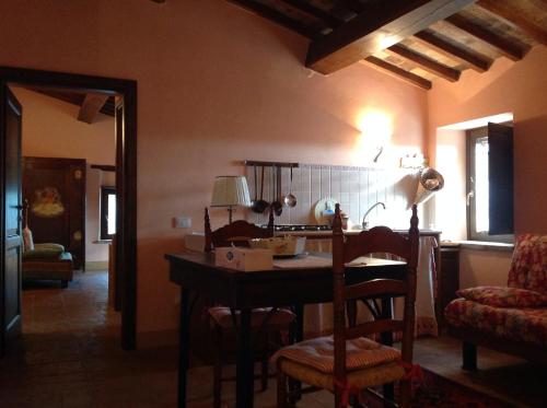 a kitchen with a table and chairs in a room at Agriturismo San Bartolomeo in Montecchio
