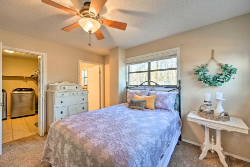 a bedroom with a bed and a ceiling fan at Pet-Friendly Shady Oaks Broken Bow Gem with Patio! in Broken Bow