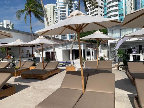 a group of chairs and umbrellas on a patio at Wala beach club in Cartagena de Indias