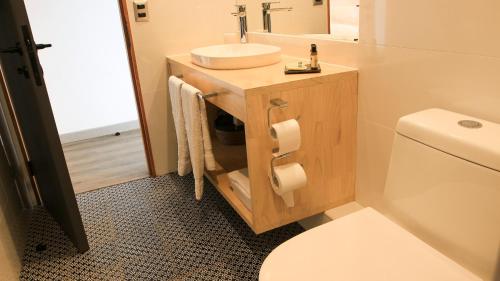 a bathroom with a sink and a toilet at CASA NEGRA SANTO DOMINGO in Santo Domingo