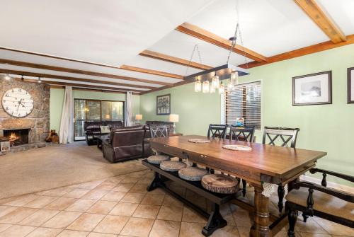 a living room with a wooden table and a fireplace at A Guest Favorite Your Smokey Mountain Escape that is fully stocked with all the comforts of home in Gatlinburg