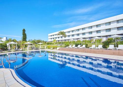 a large swimming pool in front of a building at Royal View Hotel Churaumi - Closest to Churaumi in Motobu