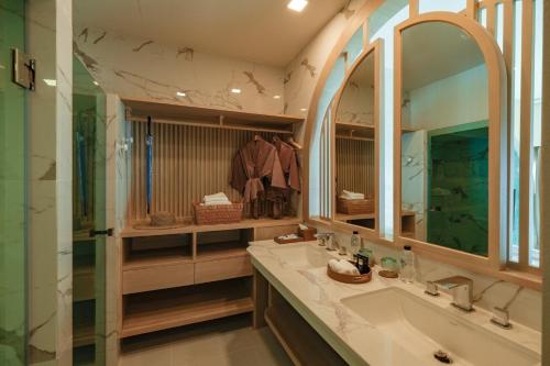 a bathroom with a sink and a mirror at Maldives Beach Resort in Chao Lao Beach