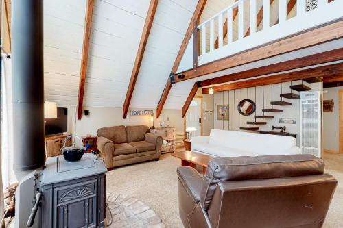 a living room with a wood stove and a couch at Cozy Cabin Retreat in South Lake Tahoe