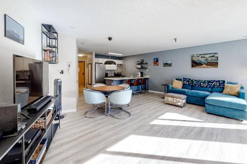 a living room with a blue couch and a table at Snowblaze Studio in Winter Park