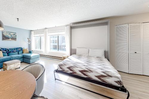a bedroom with a bed and a couch and a table at Snowblaze Studio in Winter Park