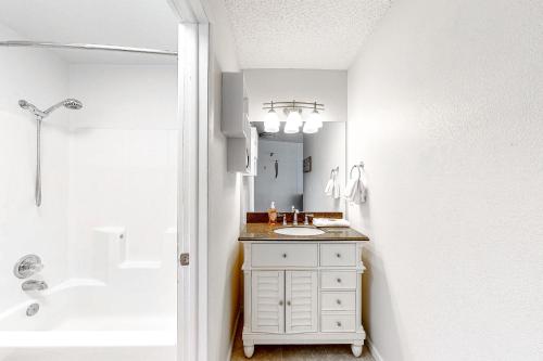 a white bathroom with a sink and a shower at Snowblaze Studio in Winter Park