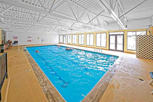 a large swimming pool with blue water in a building at Snowblaze Studio in Winter Park