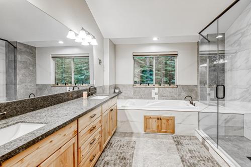 a bathroom with two sinks and a tub and a shower at Susquehana Luxury in South Lake Tahoe