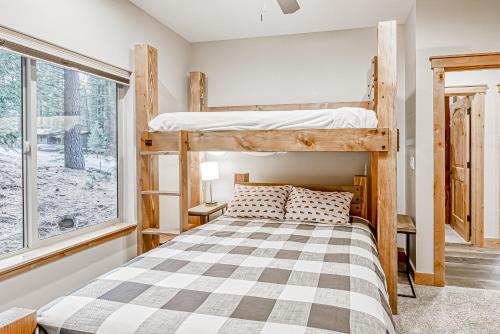 a bedroom with bunk beds and a window at Susquehana Luxury in South Lake Tahoe