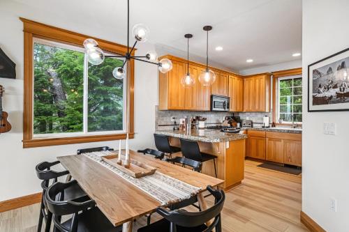 a kitchen with a wooden table and chairs at Three Capes Bungalow in Oceanside