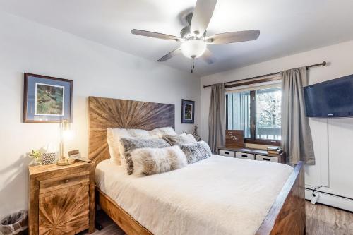 a bedroom with a large bed with a ceiling fan at Copper Valley 107 in Copper Mountain