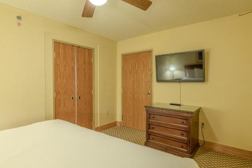 a bedroom with a bed and a tv on the wall at Grand Lodge Condo in the Heart of Mt CB condo in Crested Butte