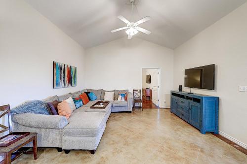 a living room with a couch and a flat screen tv at Love & Luck in Corpus Christi
