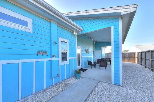 a blue house with a door leading to a patio at Love & Luck in Corpus Christi