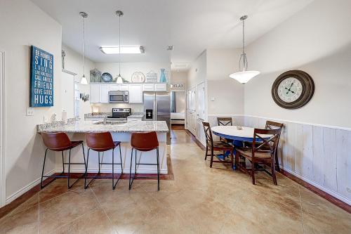 a kitchen with a counter and a table and chairs at Love & Luck in Corpus Christi