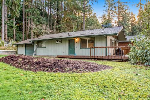 a small house with a porch and a yard at Sugarpine Retreat in Bellingham