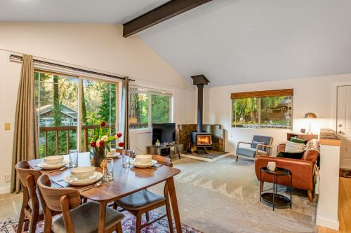 a living room with a table and chairs and a fireplace at Sugarpine Retreat in Bellingham