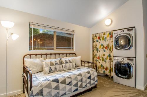a bedroom with a bed and a washing machine at Sugarpine Retreat in Bellingham
