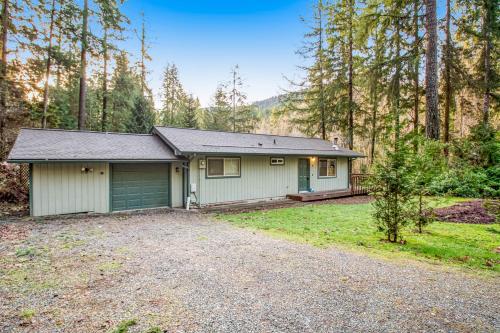 a house with a garage in the woods at Sugarpine Retreat in Bellingham