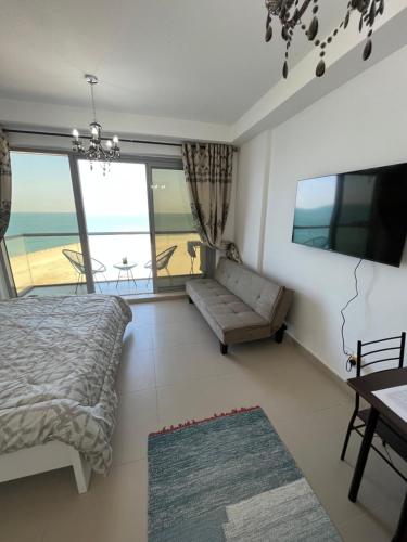 a bedroom with a bed and a view of the ocean at BEAUTIFUL STUDIO APARTMENT IN AL MARJAN ISLAND in Ras al Khaimah