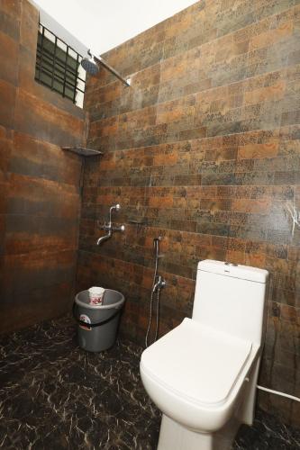a bathroom with a toilet and a sink in it at House Of Brothers in Arambol