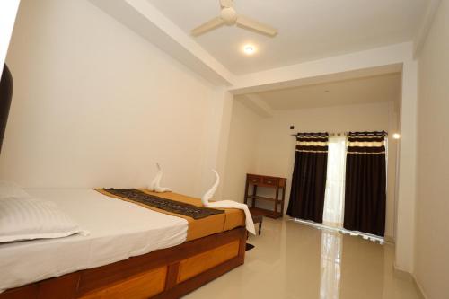 a bedroom with a bed and a ceiling fan at The House Of Brothers in Arambol