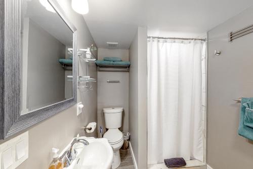 a bathroom with a toilet and a sink and a shower at Plant Your Southwest Feet in Phoenix