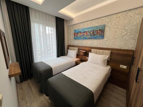 a hotel room with two beds and a window at PRIME INN CITY in Melikgazi